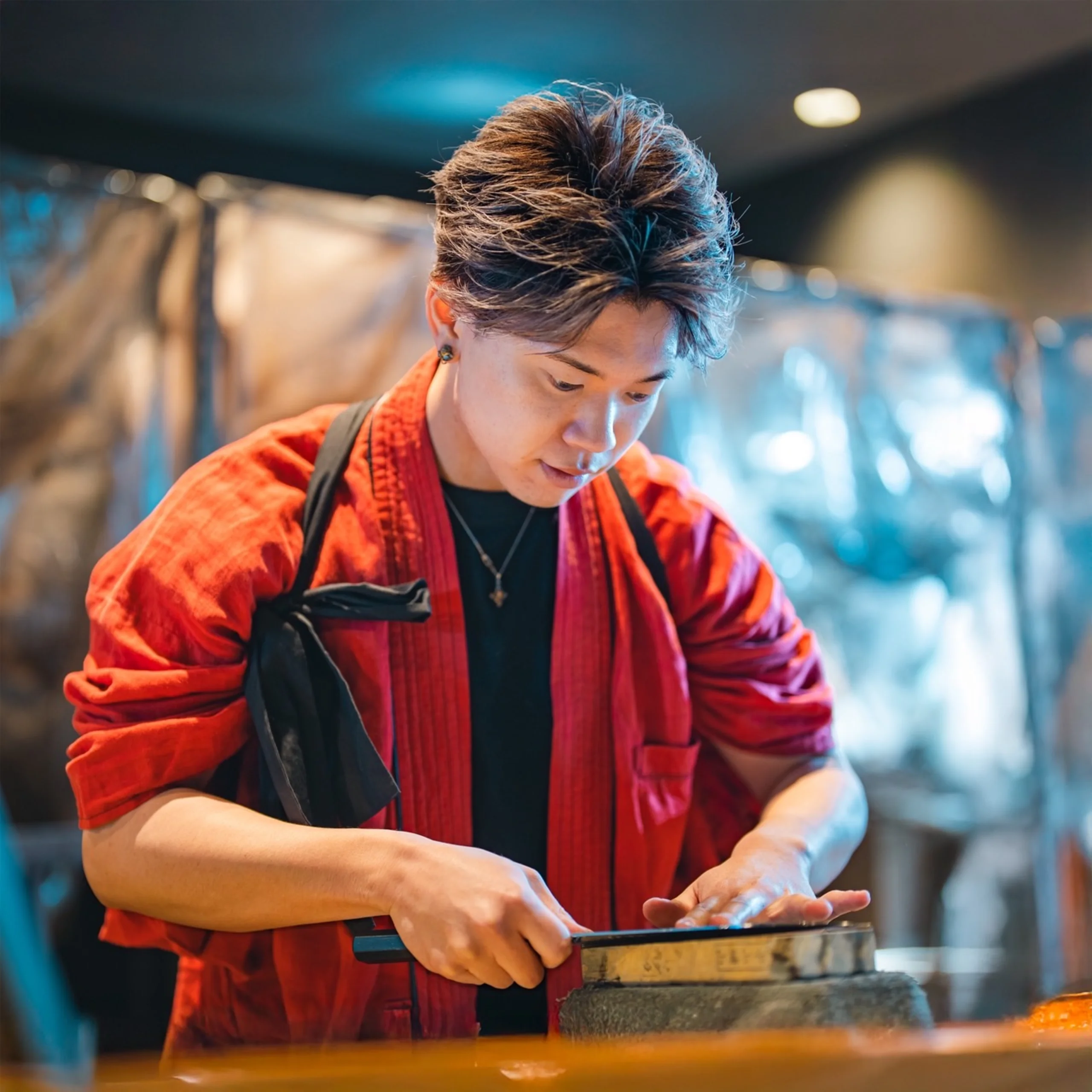 Kenshi Ryota sharpening a knife on a whetstone